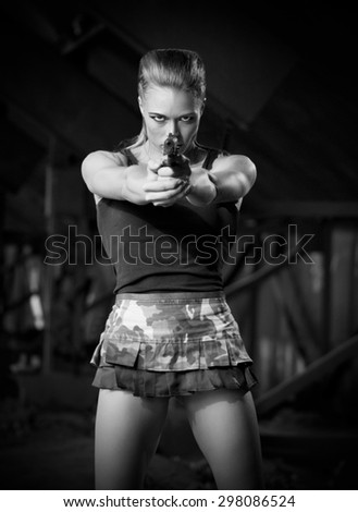 Young woman in uniform with gun (monochrome version)