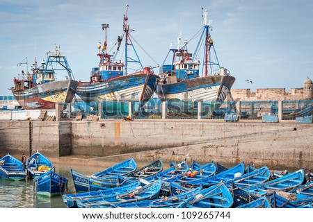 Ships and fishing boats in the harbor at the Sqala du Port, in Essaouira, Morocco, on the southern Atlantic Coast. Boats are used every day for fishing at sea, the ocean.