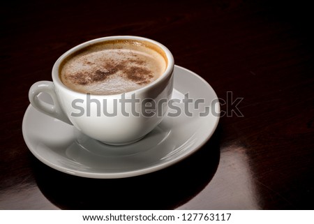 White cup of freshly brewed coffee in cafeteria