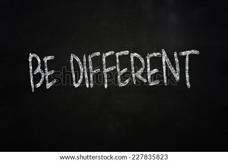 The words Be Different written with chalk on blackboard
