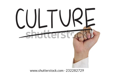 Image of a hand holding marker and write culture words isolated on white