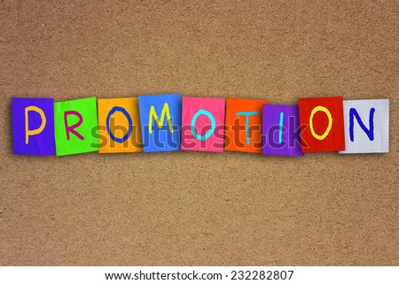 The word promotion written on sticky colored paper over cork board