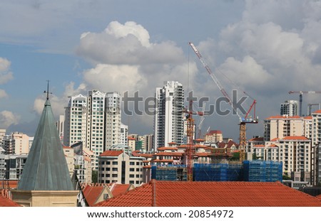singapore skyline with construction cranes under stormy sky. room for text