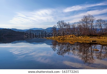 Peacefull lake, bare trees and autumn colors at Haukeli, Norway