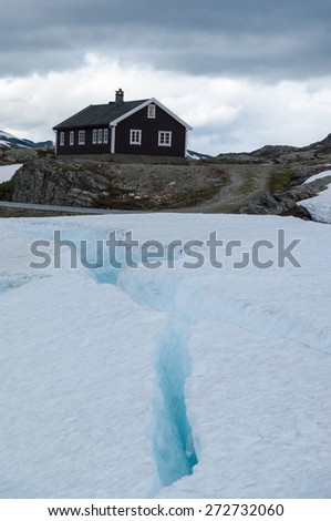 Lonely house in snow and ice mountains of Norway