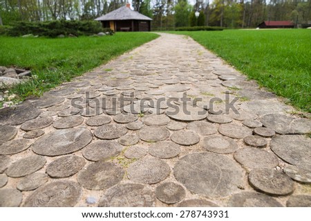 Wooden round log path closeup in summer recreation camping site