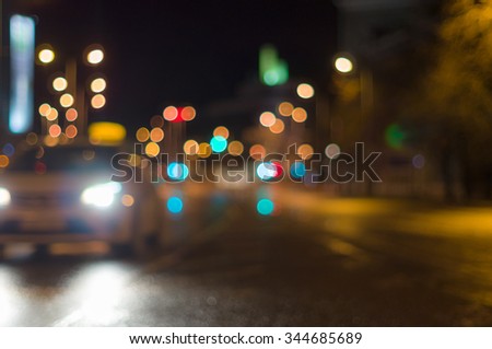 Car driving by blurred image, city road night lights on background