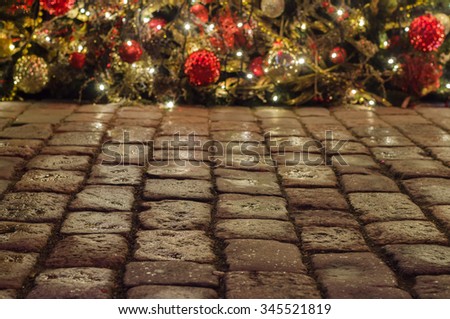 Cobblestone pavement and christmas decorations on background