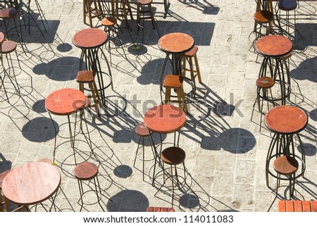 Wooden chairs and tables on bar terrace