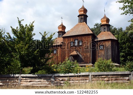 A wooden church in Ukrainian village. Beautiful ukrainian countryside. Spring sunny day. Old architecture.