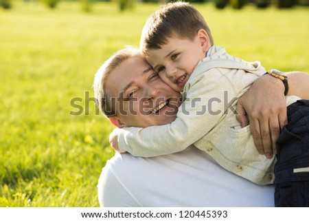 Father and son rest in the summer on the nature