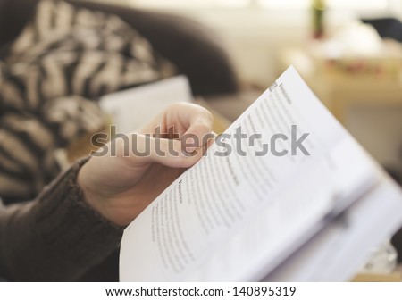 Person Holding A Book In Shallow Focus
