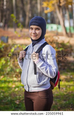teenager with a backpack on walk in autumn park, outdoor