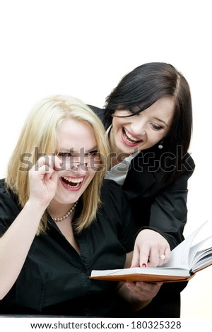 Two business women sharing ideas with each other. Shot in the studio on an isolated white background.
