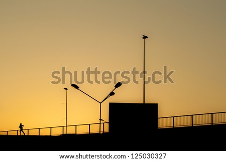 Minimal sunset cityscape with bird silhouette and runner silhouette