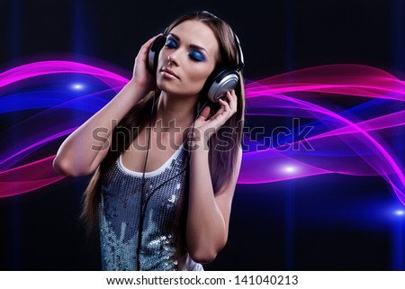 young DJ woman enjoying the music in the headphones