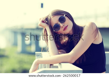young smiling woman in sunglasses outdoor