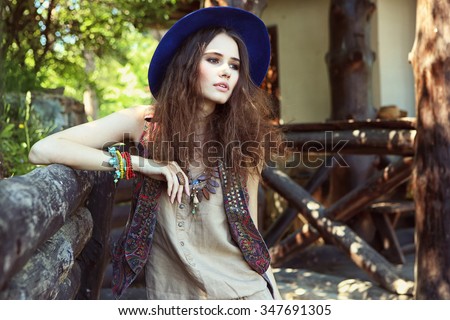Outdoor fashion portrait of young beautiful woman. Boho chic style
