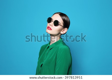 fashion model in sunglasses , beautiful young woman. Studio shot
