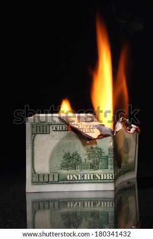 One hundred dollars in fire, burning dollar, ashes. Crisis