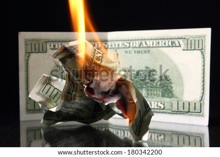 Crisis One hundred dollars in fire, burning dollar, ashes