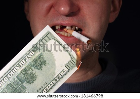 smoker with burning dollar