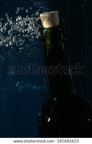 wine bottle neck on water with bubbles