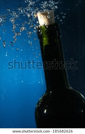 wine bottle neck in water with bubbles