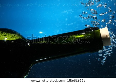 wine bottle neck on water with bubbles
