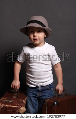 Little boy with big bag in hat