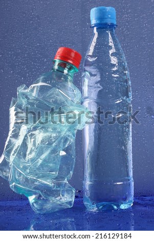 Used plastic bottle and bottle of water