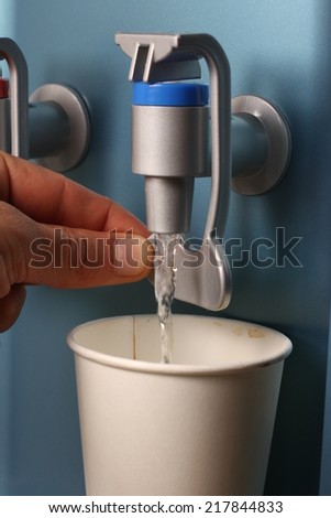 filling cup at water cooler, water dispenser