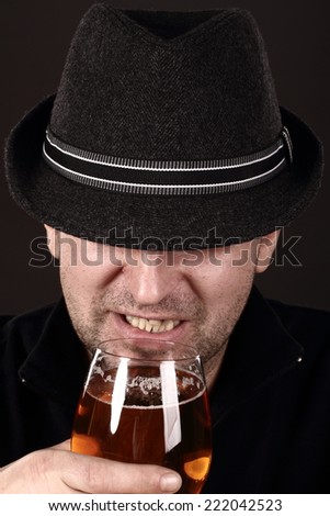 alcoholic in despair drinking beer, bad teeth