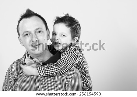 Father and son hugging, angry kid