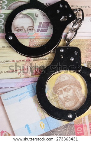 Criminal. Handcuffs and money. Corruption