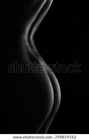 Sexy body nude woman buttocks. Naked sensual beautiful back. Black and white artistic photo. classic low key
