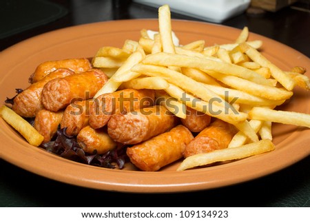 Sausage and french fries on plate