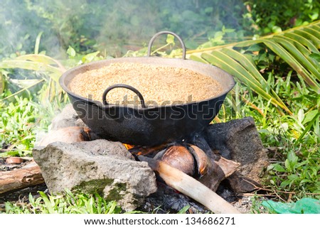 Preparing/boiling paddy in a rural village in Sri Lanka in order to get rice for household use.