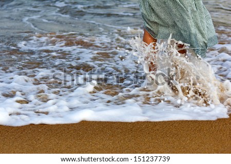 nice legs of a pretty girl on a sandy beach
