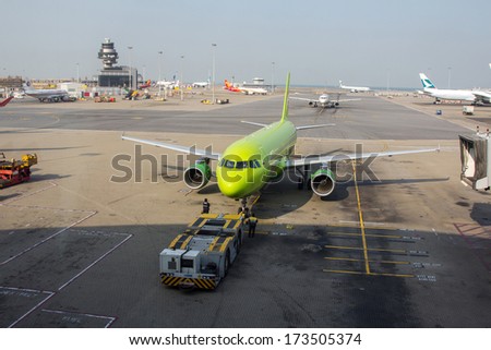 HONG KONG, CHINA - DEC 29, 2013: Preparing S7 Airlines airplane for flight in Hong Kong International Airport. About 90 airlines operate flights from HKIA to over 150 cities across the globe.
