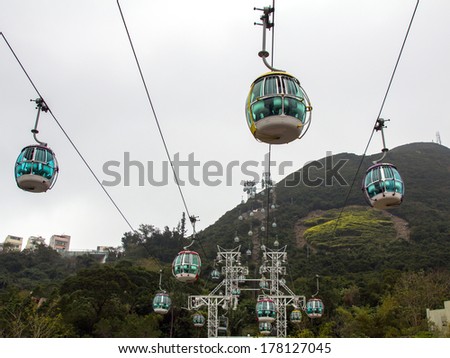 HONGKONG - FEB 04, 2014: Cable cars in Ocean Park, Hongkong on a misty day. Cablecar carries tourists up to the entertainment park. Ocean Park also a center for giant panda breeding.