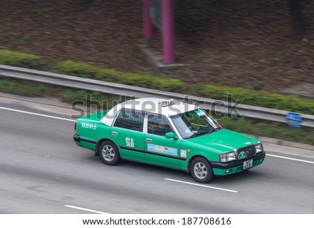 HONG KONG, CHINA - APR 13, 2014: New Territories taxi moving past in a highway in Tuen Mun district  Most taxis are independently owned and operated, but some are owned by taxi companies