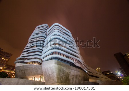 HONG KONG - APR 29, 2014: Night view of the Jockey Club Innovation Tower is home to Hong Kong Polytechnic University\'s School of Design. Designed by Pritzker-prize-winning architect Zaha Hadid