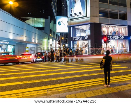 HONG KONG - MAY 10, 2014: People waiting to cross a busy street in Hong Kong  Hong Kong is one of the most densely populated areas in the world