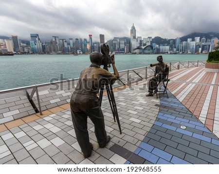 HONG KONG - MAY 15, 2014: Statue and skyline in Avenue of Stars in Hong Kong, China. The promenade honors celebrities of the Hong Kong film industry as the famous city attraction.
