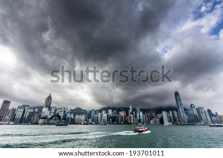 View of Victoria harbor just before a tropical cyclone  During summer, typhoons regularly skirt the city, causing varying degrees of damage including injuries and deaths