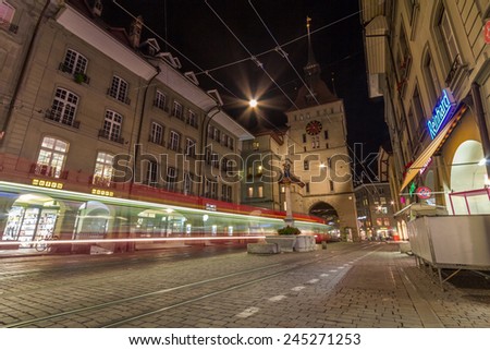 BERN, SWITZERLAND - OCT 24, 2014: Shopping alley with the famous clocktower of Bern on Switzerland.