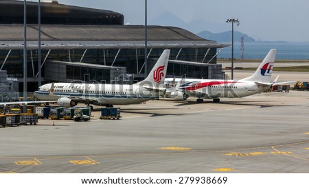 HONG KONG - APR 30, 2015:  Air China and Malaysian Airlines flights in Hong Kong International Airport. About 90 airlines operate flights from HKIA to over 150 cities across the globe.