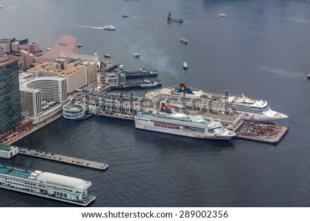 HONG KONG - JUNE 12, 2015: Two passenger cruise ships belongs to Star Cruises docked at Star Ferry Pier in Hong Kong Victoria Harbor. Star Cruises is the third largest cruise line in the world.