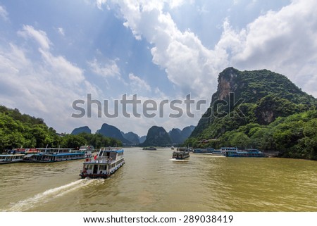 GUILIN, CHINA - MAY 02, 2015: Cruise ship packed with tourists travels the magnificent scenic route along the Li river from Guilin to Yangshou.